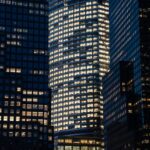 Modern commercial office high-rise building with illuminated windows at night in Pune