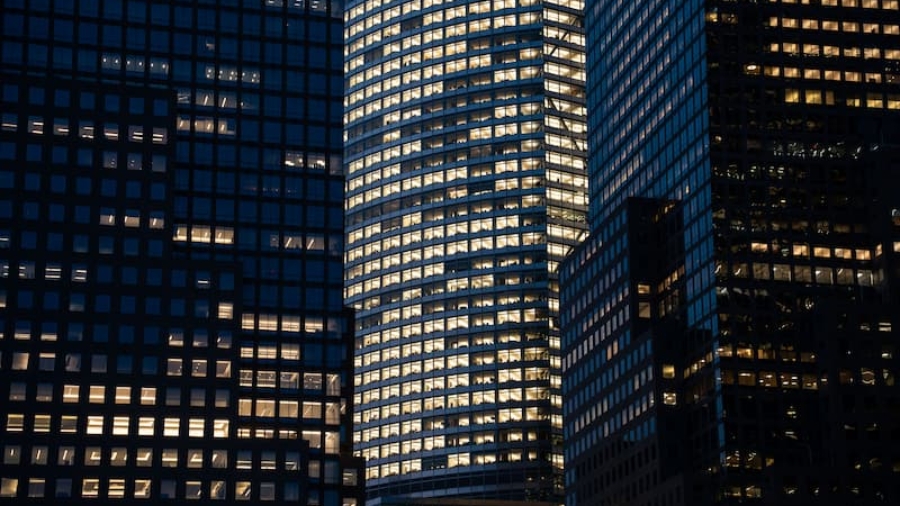 Modern commercial office high-rise building with illuminated windows at night in Pune
